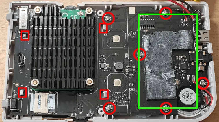 An opened GPi Case 2, showing the screws that need to be removed in order to extract the PCB from the case.